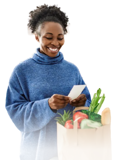 Woman with bag of groceries looking at receipt