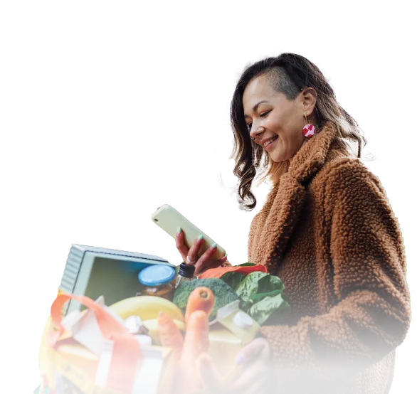 Woman with shopping bag looking at phone