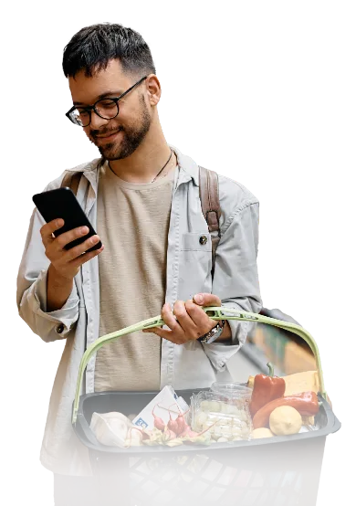 Man with basket of groceries looking at phone