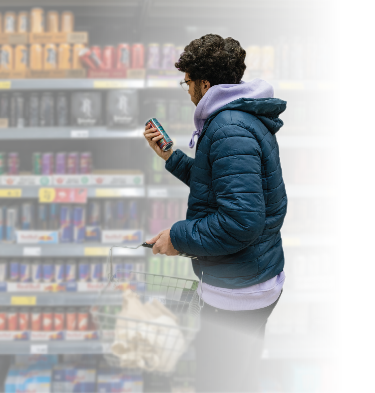 A man shopping, while holding a shopping basket.